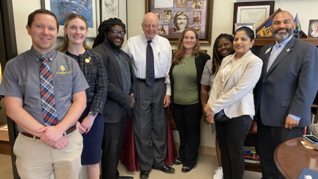 Alums, Huff and Leck with lawmakers